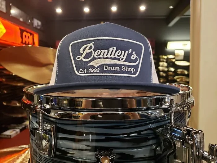 Bentley’s Drum Shop Trucker Snapback Hat in Navy Blue and White